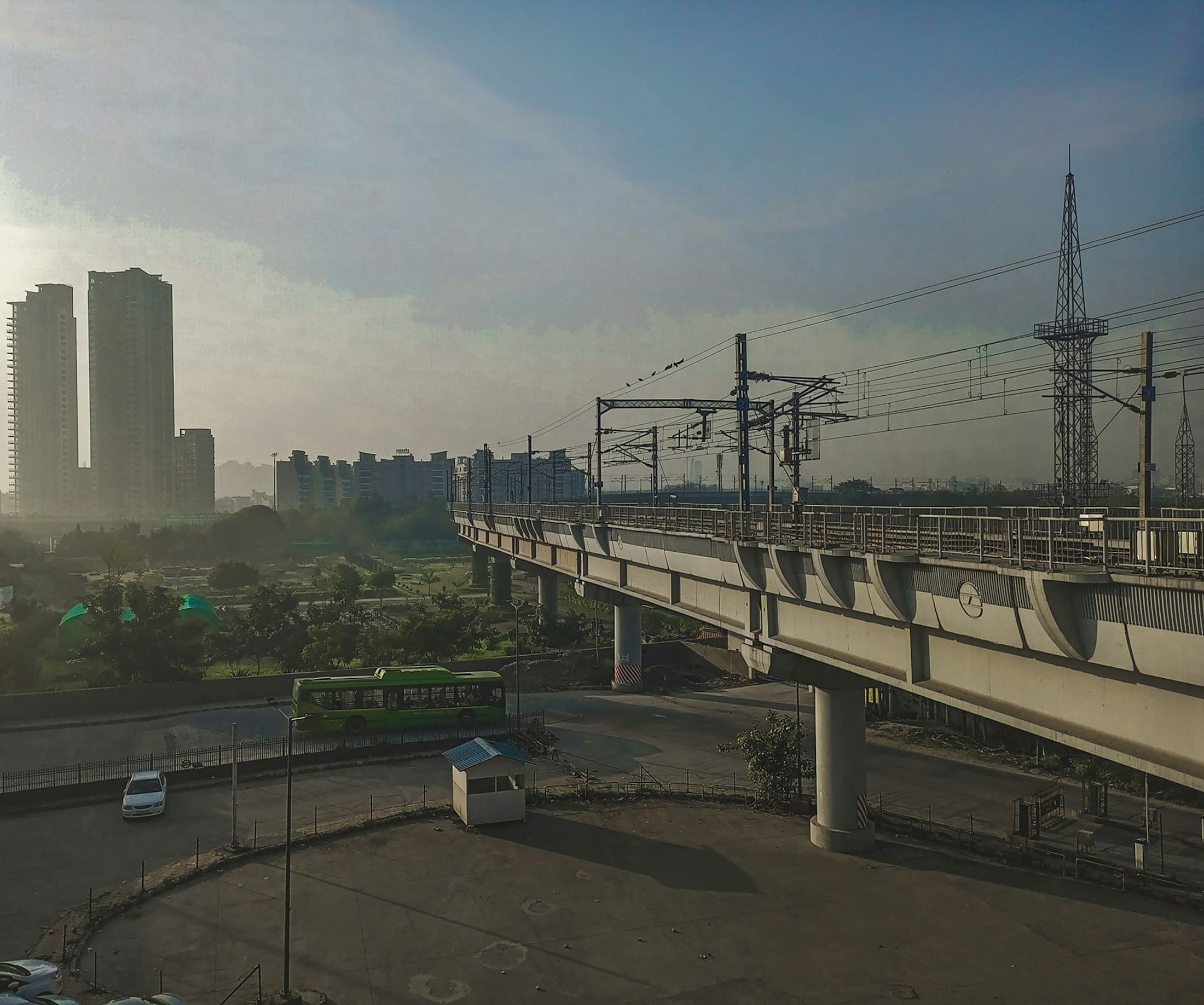 An elevated metro line running past high-rise blocks in Noida